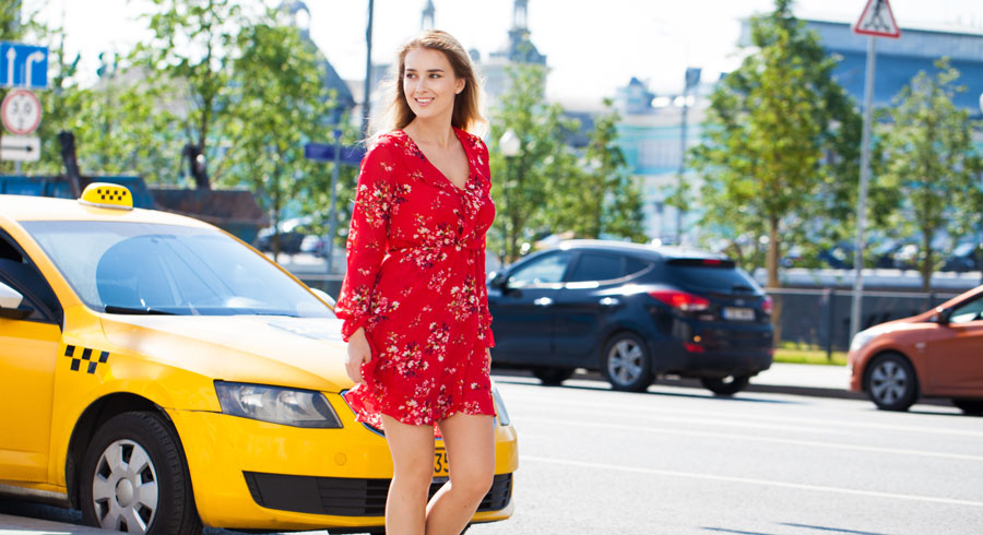 une femme aborde un taxi dans la rue