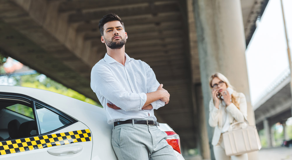 chauffeur de taxi attends sa passagère